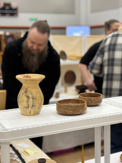 Artist displaying handmade pottery at Art in the Burg