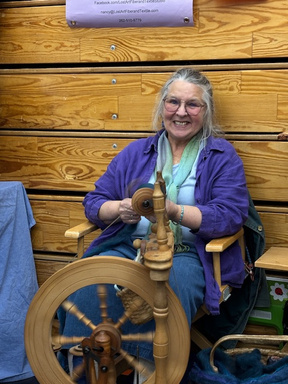 Artist with spinning wheel at Art in the Burg